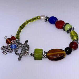 Unique beaded bracelet, glass beads, silver tone findings, cross, 6"